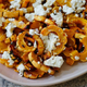 Roasted delicata squash with goat cheese on platter